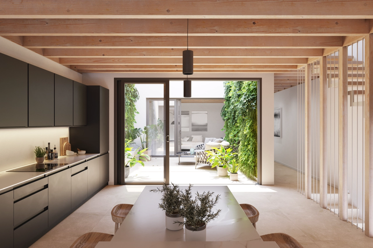 Det moderna köket är designat för funktionalitet och öppnar upp mot den centrala uteplatsen.