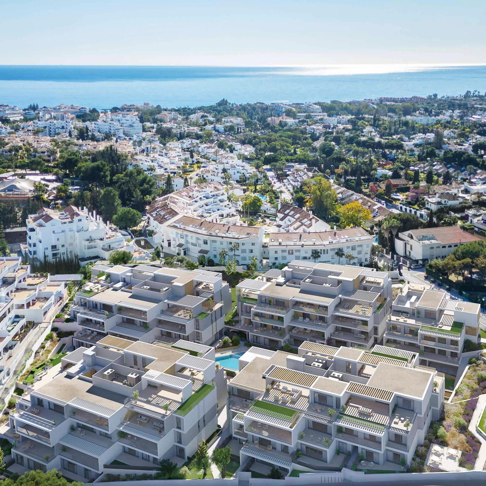 En flygvy över Isla Bela-området, som visar dess moderna design och närhet till Medelhavet.