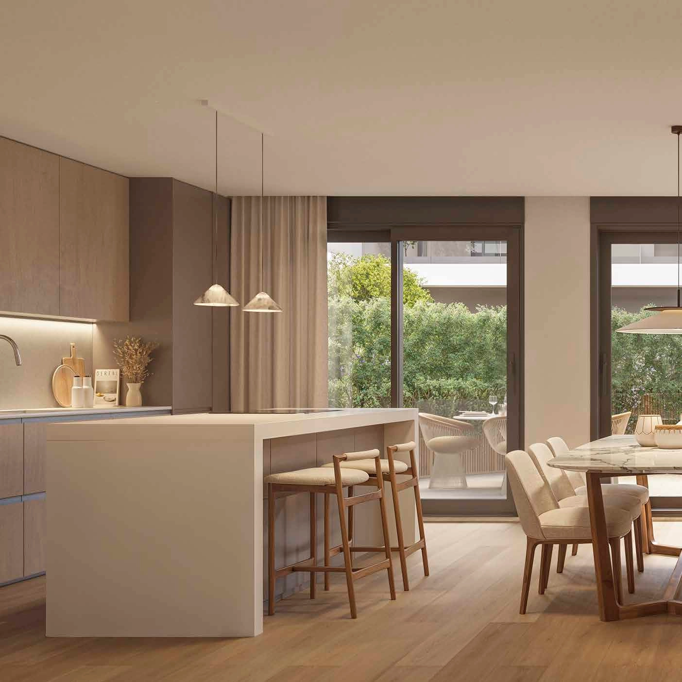 Ett modernt kök av hög kvalitet som öppnar upp mot matplatsen, perfekt för att underhålla gäster.