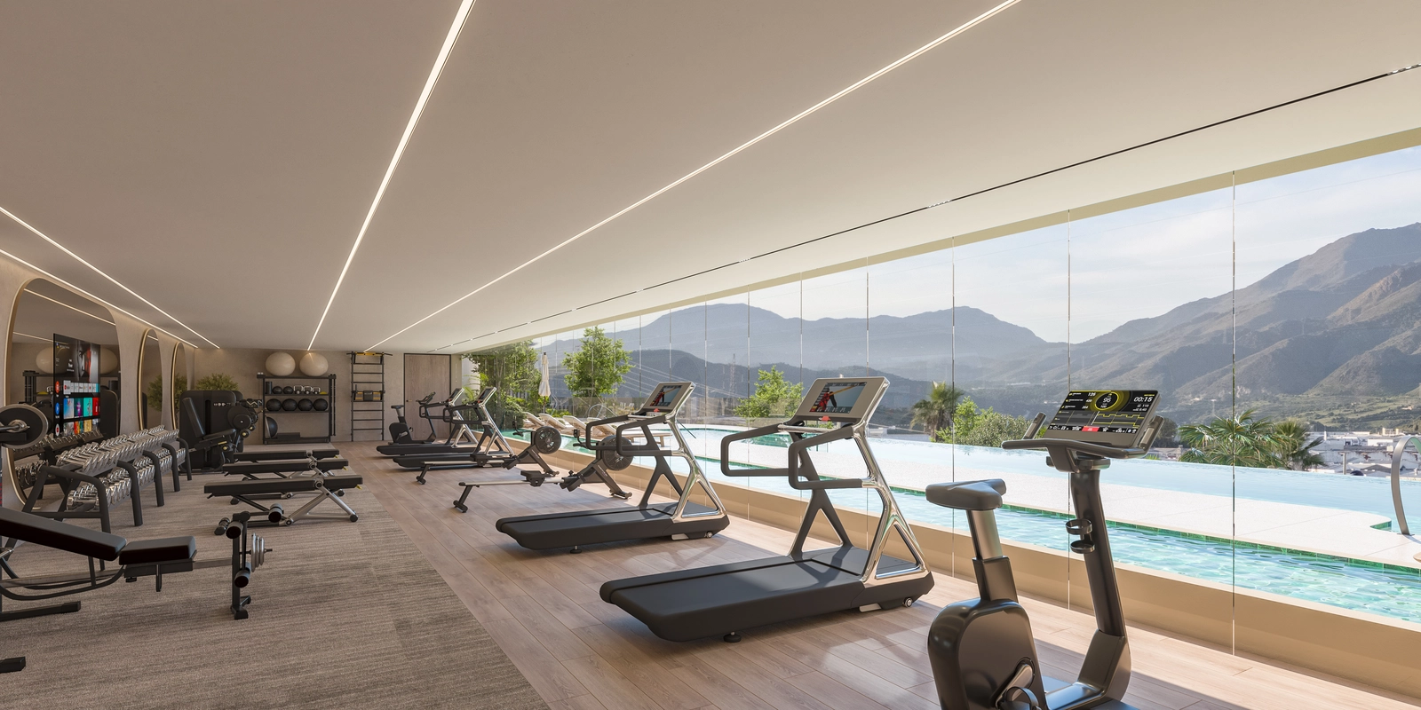 Det toppmoderna fitnesscentret, fullt utrustat och med utsikt över poolen och bergen för ett inspirerande träningspass.