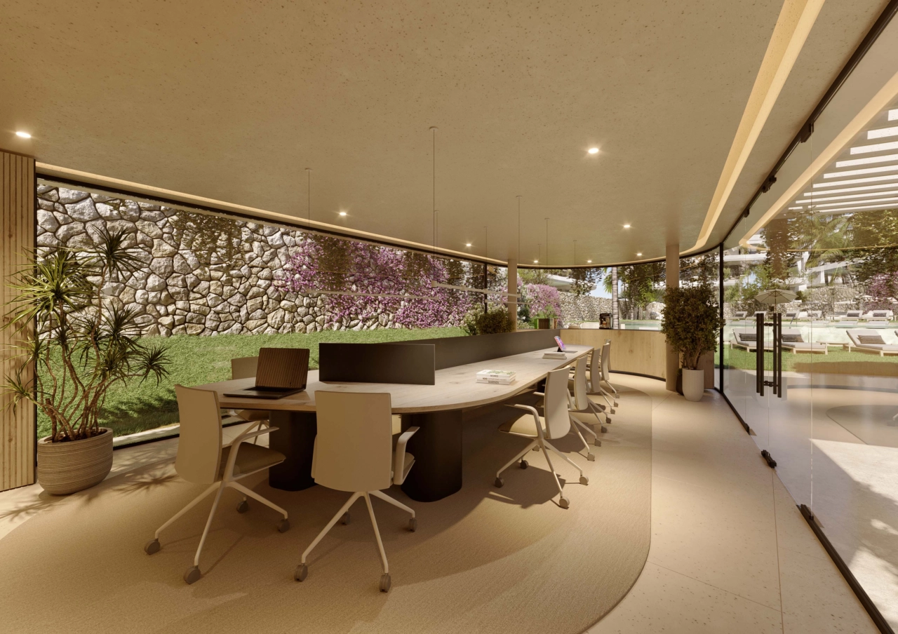 En lugn co-workingyta med utsikt över trädgården, som erbjuder en bekväm och inspirerande miljö för arbete eller möten.