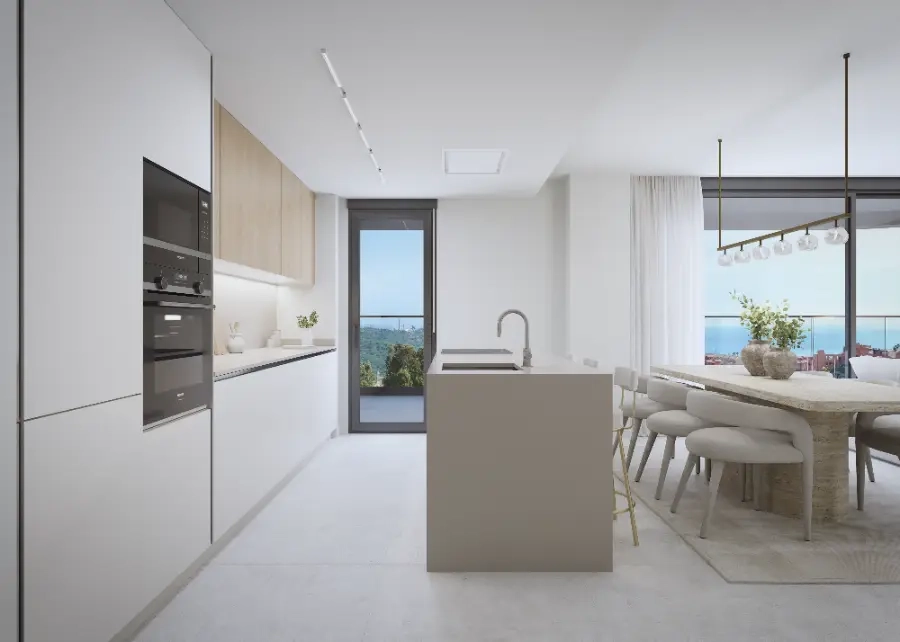 Ett modernt, fullt utrustat kök som flyter samman med vardagsrummet, perfekt för underhållning.